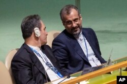 Iran's delegates look at each other while U.S. Secretary of State Antony Blinken addresses the 2022 Nuclear Non-Proliferation Treaty review conference, in the United Nations General Assembly, Aug. 1, 2022.