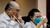 Lee Ming-che (left), a Taiwanese democracy activist who was imprisoned in China for five years, takes part in a press conference with his wife, Lee Ching-yu, at the parliament in Taipei on May 10, 2022.