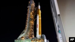 The NASA Artemis rocket with the Orion spacecraft aboard leaves the Vehicle Assembly Building moving slowly to pad 39B at the Kennedy Space Center in Cape Canaveral, Fla., Tuesday, Aug. 16, 2022. (AP Photo/Terry Renna)