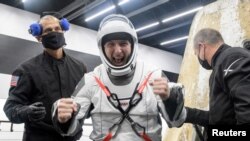 NASA astronaut Mike Hopkins is helped out of the SpaceX Crew Dragon Resilience spacecraft onboard the SpaceX GO Navigator recovery ship after he, NASA astronauts Shannon Walker, Victor Glover and Japan Aerospace Exploration Agency (JAXA) astronaut Soichi Noguchi landed in the Gulf of Mexico off the coast of Panama City, Florida, U.S. May 2, 2021.