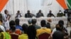 FILE - Ivory Coast officials address the relatives of the 49 Ivorian soldiers detained in Mali, in Abidjan, Aug. 3, 2022.