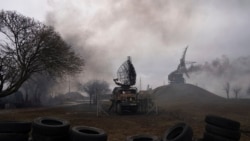 Smoke rise from an air defence base in the aftermath of an apparent Russian strike in Mariupol, Ukraine, Feb. 24, 2022.
