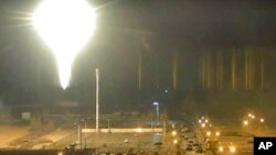 This image made from a video released by Zaporizhzhia nuclear power plant shows bright flaring object landing in grounds of the nuclear plant in Enerhodar, Ukraine March 4, 2022. 