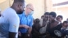 FILE - UNCEF's Rudolf Schwenk, second left, talks with mothers displaced by floods at Bangula evacuation camp in the Nsanje district, Malawi, Feb. 8, 2022. Authorities say the polio vaccine will reach children in evacuation camps. (Lameck Masina/VOA)