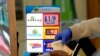 A customer is handed Powerball tickets purchased at Lichine's Liquor & Deli in Sacramento, Calif., Nov. 7, 2022. 
