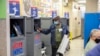 A poll worker prints a ballot from a Board of Elections printing machine at an early voting polling site at Frank McCourt High School in New York, Nov. 1, 2022.