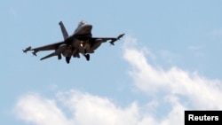 FILE - A Turkish F-16 fighter jet approaches Incirlik Air Base in Adana, Turkey, July 3, 2012. Greece has blocked Turkey from joining an upcoming NATO exercise because of what Athens says is a record number of airspace violations by armed Turkish jets.