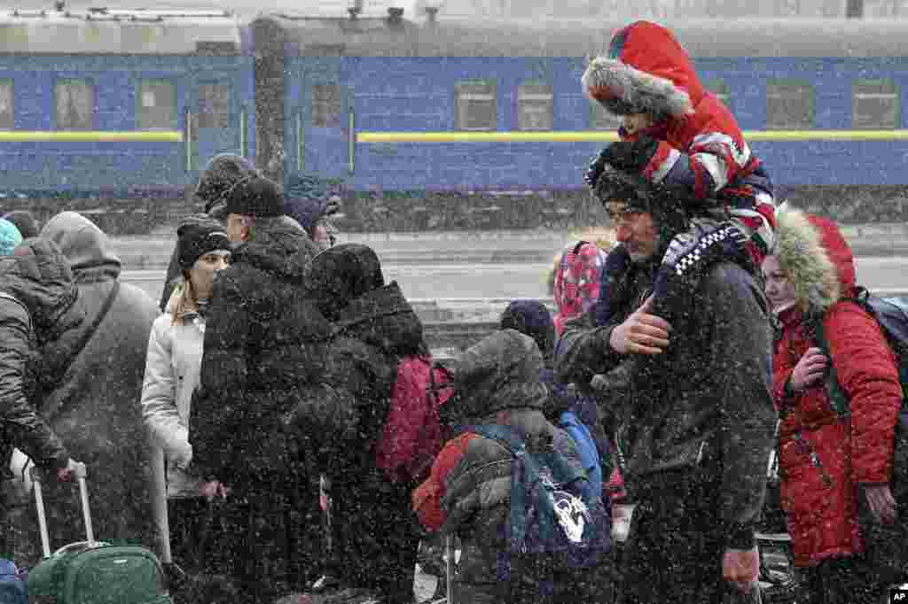 People wait to catch a train and leave Kramatorsk for western Ukraine at the railway station in Kramatorsk, March 9, 2022.
