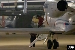 WNBA star Brittney Griner exits a plane in San Antonio, Texas, after she was released from a Russian prison in exchange for an arms dealer.