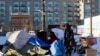 A man stands outside of a tent in the city of Denver, Colorado, in the United States, Dec. 22, 2022. City officials and outreach workers across the U.S. were rushing to get people off the streets and indoors during harsh winter conditions in December, 2022.