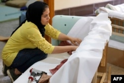 Iraqi carpenter Nour al-Janabi works at her home furniture workshop in Baghdad's Abu Dsheer area, on Nov. 13, 2022.