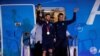 Lionel Messi holds out the trophy during the team's arrival in Buenos Aires, Dec. 20, 2022, after after winning the World Cup.