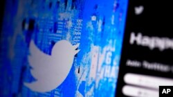FILE - The Twitter splash page is seen on a digital device, April 25, 2022, in San Diego. European Union data show that Twitter took longer to review hateful content and removed less of it in 2022 compared with the previous year. 