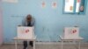 A man votes at a polling station during parliamentary election in Tunis, Tunisia Dec. 17, 2022. 