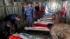 The bodies of Iraq's federal police members who were killed in suspected IS attack, are repatriated from Kirkuk airport in northern Iraq on Dec. 18, 2022.
