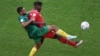 Switzerland's Breel Embolo fights for the ball with Cameroon's Jean-Charles Castelletto during the World Cup group G soccer match at the Al Janoub Stadium in Al Wakrah, Qatar, Nov. 24, 2022.