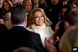 FILE - People applaud former Arizona Rep. Gabby Giffords as she arrives in the East Room of the White House in Washington, Jan. 5, 2016.