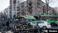 A views shows a building and vehicles destroyed by shelling as Russia's attack on Ukraine continues, in Kyiv, Ukraine, March 14, 2022.