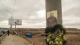 The picture of a fallen Ukrainian soldier is displayed on a light post at the bridge that links Irpin to Kyiv, in Ukraine, March 13, 2022. 