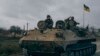 Ukrainian soldiers ride a captured Russian APC in Kherson, Ukraine, Sunday, Nov. 13, 2022.