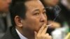 FILE - Liu Han, former chairman of Hanlong Mining, smokes a cigarette during a conference in Mianyang, Sichuan province.