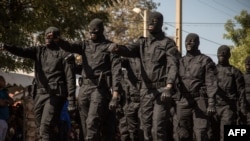Des policiers maliens défilent devant les chefs du gouvernement de transition lors d'une cérémonie célébrant la fête nationale de l'armée, à Kati, le 20 janvier 2022.