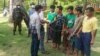 Officials talk to survivors from a boat that left from Rakhine state but capsized, in Pathein district, about 200km west of Yangon, in this photo taken May 22, 2022, and received May 24, 2022, courtesy of an anonymous source.