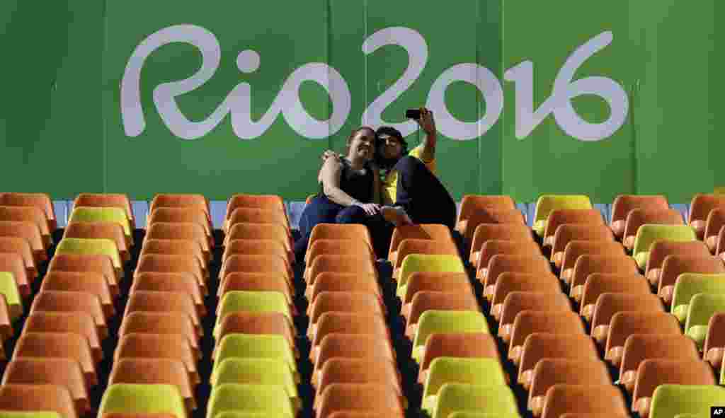 A couple takes a selfie during the women's rugby sevens match between Australia and Colombia at the Summer Olympics in Rio de Janeiro, Brazil, Aug. 6, 2016.