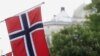 FILE - Norwegian flags flutter at Karl Johans street in Oslo, Norway, May 31, 2017. 