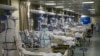 FILE - Medical workers in protective suits attend to COVID-19 patients at the intensive care unit of a designated hospital during the COVID-19 outbreak in Wuhan, China, Feb. 6, 2020. (China Daily via Reuters)