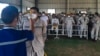Petugas kesehatan memeriksa suhu tubuh pekerja PT Indonesia Morowali Industrial Park di Morowali, Sulawesi Tengah. (Foto: AFP)