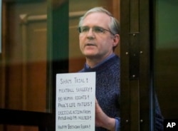 FILE - Paul Whelan, a former U.S. marine, listens to the verdict in a courtroom at the Moscow City Court in Moscow, Russia, June 15, 2020.