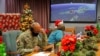 FILE - In this photo released by the US Department of Defense, volunteers answer phones and emails from children around the globe during annual NORAD Tracks Santa event at Peterson Air Force Base in Colorado Springs, Colo., on Dec. 24, 2021.