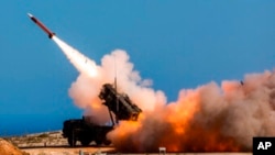FILE - German soldiers fire the Patriot weapons system at the NATO Missile Firing Installation, in Chania, Greece, on Nov. 8, 2017.