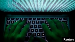 FILE - A man types on a computer keyboard in Warsaw, Poland, in this Feb. 28, 2013, illustration photo.