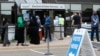 FILE - Voters, among them Somali Americans, line up to cast their ballots in primary elections, at the Minneapolis Election and Voters Services offices, in Minneapolis, Minnesota, Aug. 10, 2020.