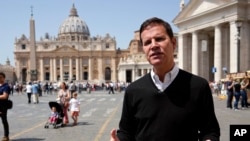 Juan Carlos Cruz, the key whistleblower in Chile's clerical sex abuse scandal, is backdropped by St.Peter's Basilica during an interview with The Associated Press, in Rome, April 24, 2018.