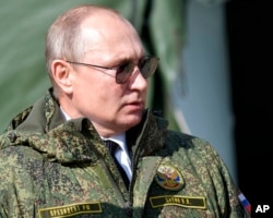 FILE - Russian President Vladimir Putin arrives to watch the military exercises Center-2019 at Donguz shooting range near Orenburg, Russia, on Sept. 20, 2019.
