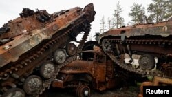 FILE - Destroyed Russian tanks and armored vehicles from Russia's invasion of Ukraine are seen stacked up in the liberated town of Lyman, Donetsk region, Ukraine, Oct. 5, 2022. 