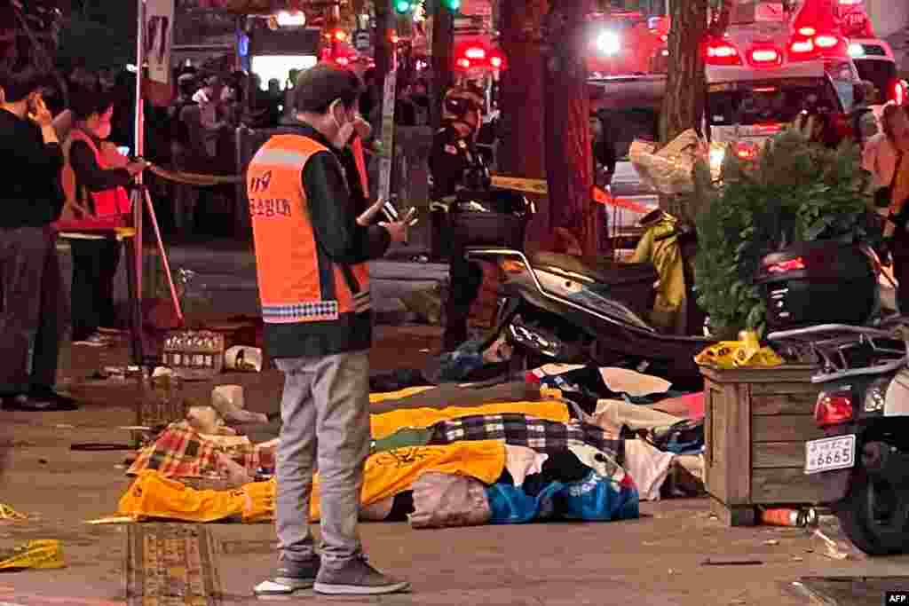 Bodies of victims, believed to have suffered cardiac arrest during a crush, are covered with blankets in the popular nightlife district of Itaewon, in Seoul, South Korea, Oct. 30, 2022.