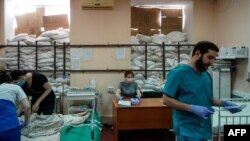 FILE - Medical staff tend to children in a room protected by sandbags at the Zaporizhzhia Regional Clinical Children's Hospital on March 22, 2022. 