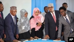 Somali lawmakers are sworn-in to office at a ceremony held in the capital's heavily fortified Halane military camp in Mogadishu, Somalia, April 14, 2022. 