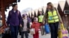 FILE - Ukrainian refugees walk on the platform after arriving on a train from Odesa at Przemysl Glowny train station, after fleeing the Russian invasion of Ukraine, in Przemysl, Poland, April 10, 2022. 