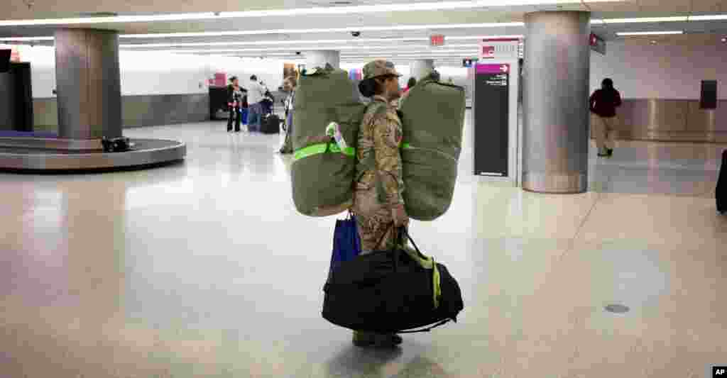 Tentara Angkatan Darat AS Sersan Angelica Ciriaco bersiap pulang ke rumah dari Bandar Udara Internasional Miami setelah bertugas 10 bulan di Afghanistan (26/11).&nbsp;(AP/J. Pat Carter)