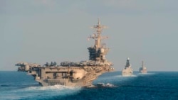 The aircraft carrier USS Abraham Lincoln, left, the air-defense destroyer HMS Defender and the guided-missile destroyer USS Farragut transit the Strait of Hormuz in this Nov. 19, 2019, photo made available by U.S. Navy.