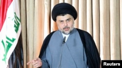 FILE - Iraq's Shi'ite religious cleric Moqtada al-Sadr gives a speech in Najaf, June 25, 2014. Sadr condemned the kidnapping of 18 Turkish workers in Baghdad and said he was ready to assist the government in securing their release.