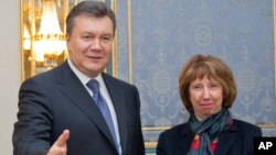 Ukrainian President Viktor Yanukovych, left, greets EU foreign policy chief Catherine Ashton in Kiev, Ukraine, Tuesday, Dec. 10, 2013. 