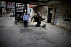FILE - A youth controls a soccer ball outside apartments in the Fuerte Apache neighborhood in Buenos Aires, Argentina, June 15, 2020. The Argentina office of UNICEF says the child poverty rate in Argentina could reach 58.6% by year's end.