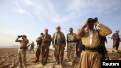 Kurdish Peshmerga forces stand guard near the town of Makhmur, south of Erbil, capital of Iraqi Kurdistan after Islamic State (IS) insurgents withdrew August 18, 2014.