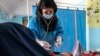 FILE - A midwife from NGO Save the Children provides Zarmina, 25, who is five months pregnant, with a pre-natal check-up, in Jawzjan province in northern Afghanistan, Oct. 2, 2022. (Save the Children via AP)